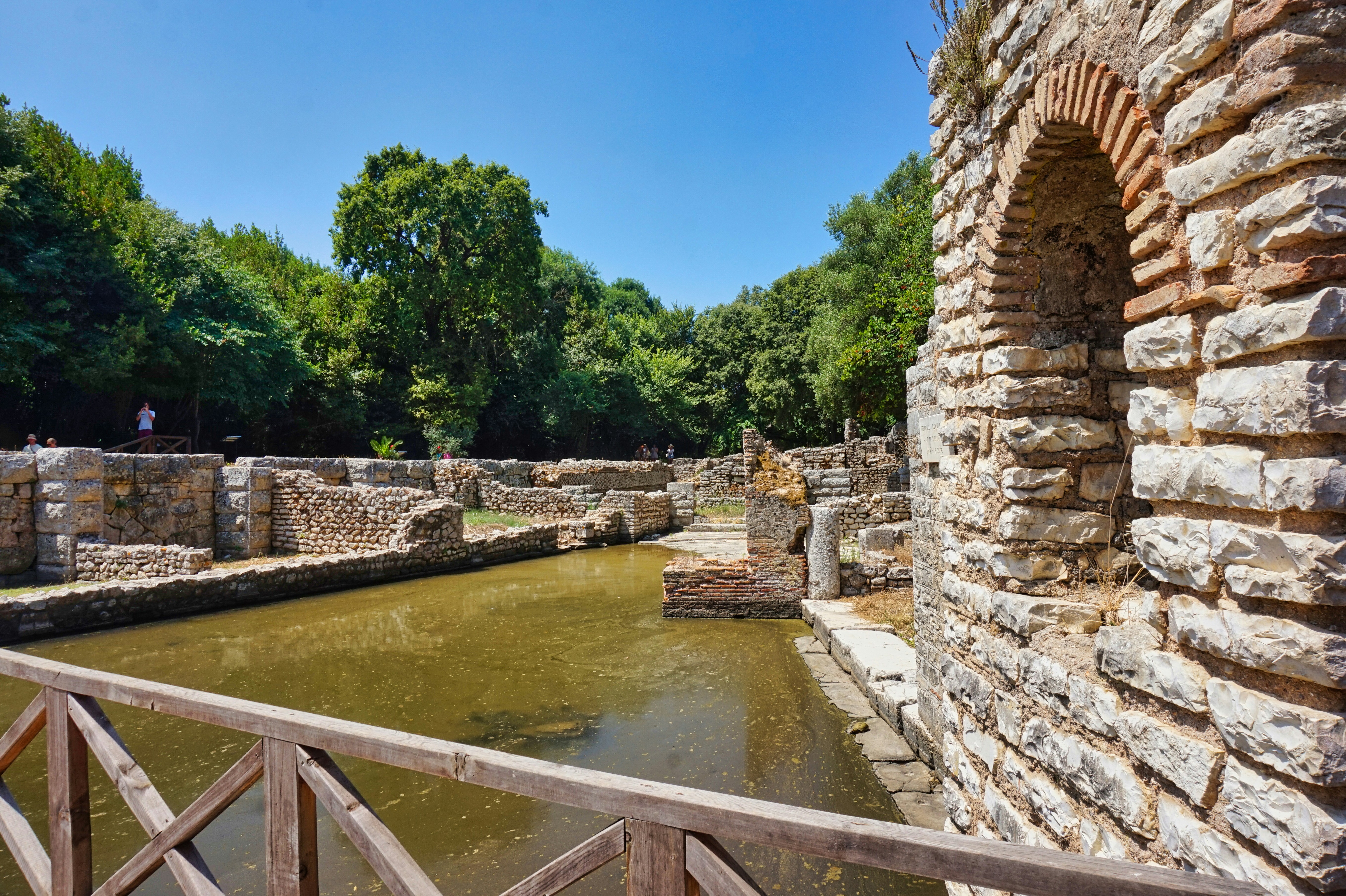 Ancient Roman and Byzantine ruins at Butrint National Park, Albania, with water and green trees