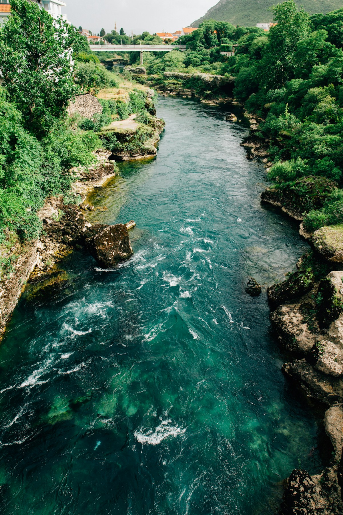 The Neretva River running through lush green hills near Mostar, Bosnia