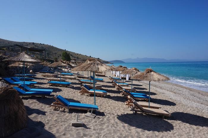 Colourful beach umbrellas and chairs at Shpellave Beach, Albanian Riviera