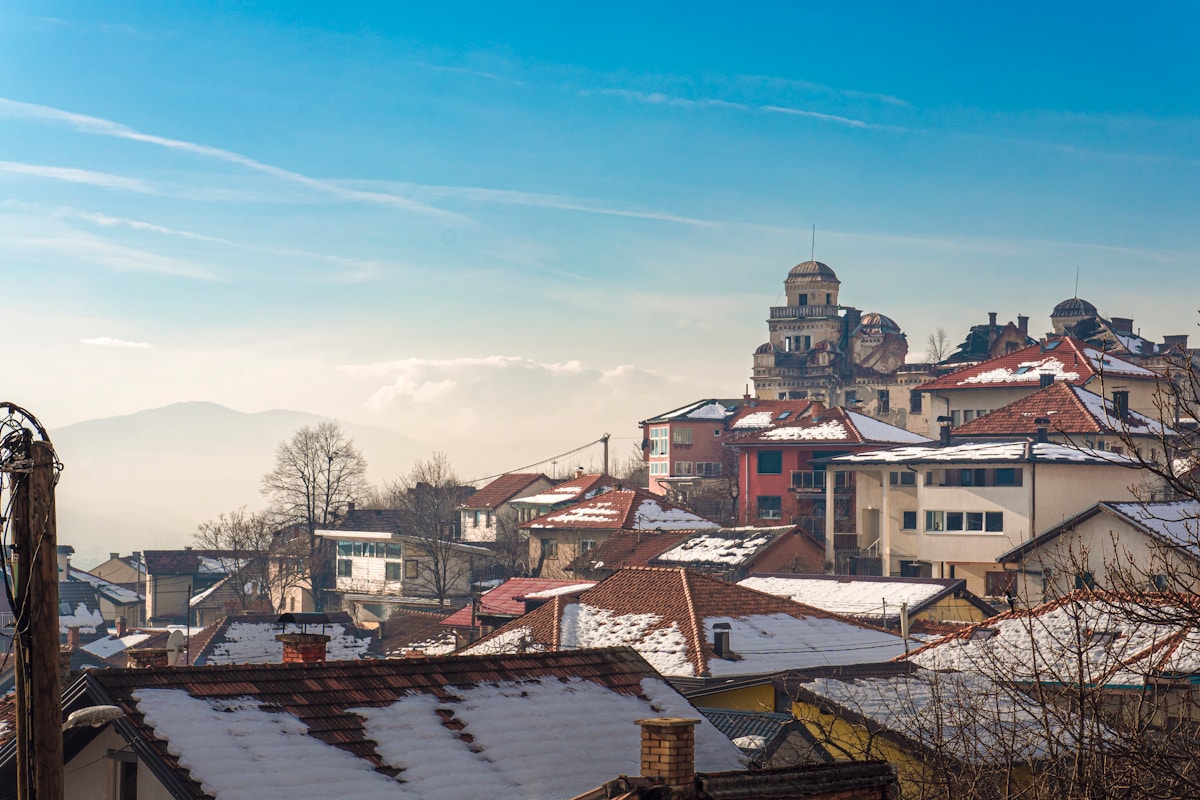 Snow-covered rooftops of Sarajevo with mountains, Bosnia — Balkans in December