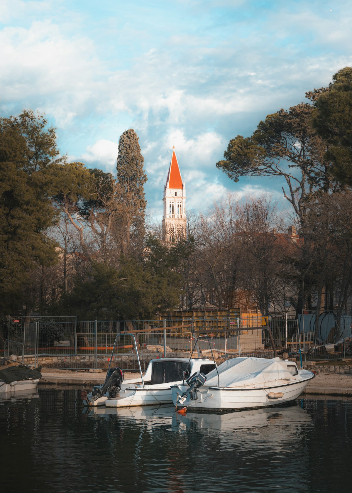 White boat and church steeple in Trogir, Dalmatian coast, Croatia