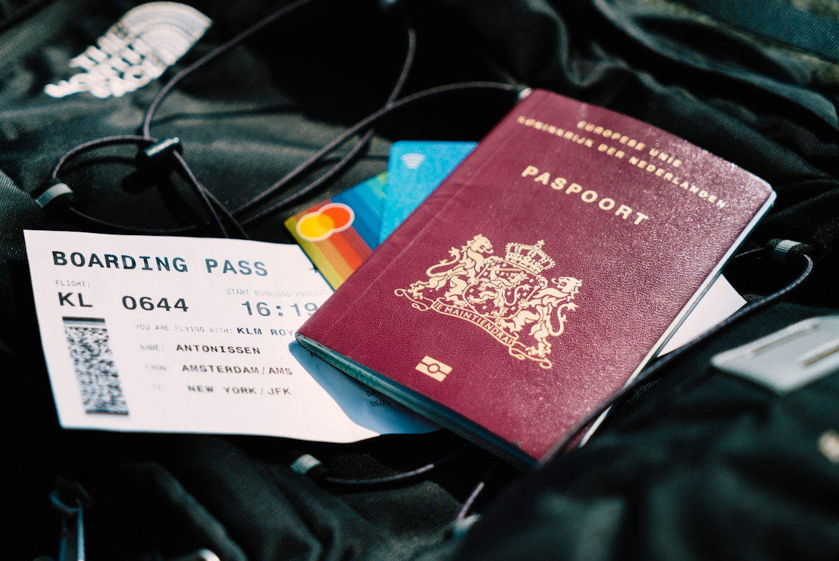 Passport and boarding pass on a bag - travel insurance for the Balkans