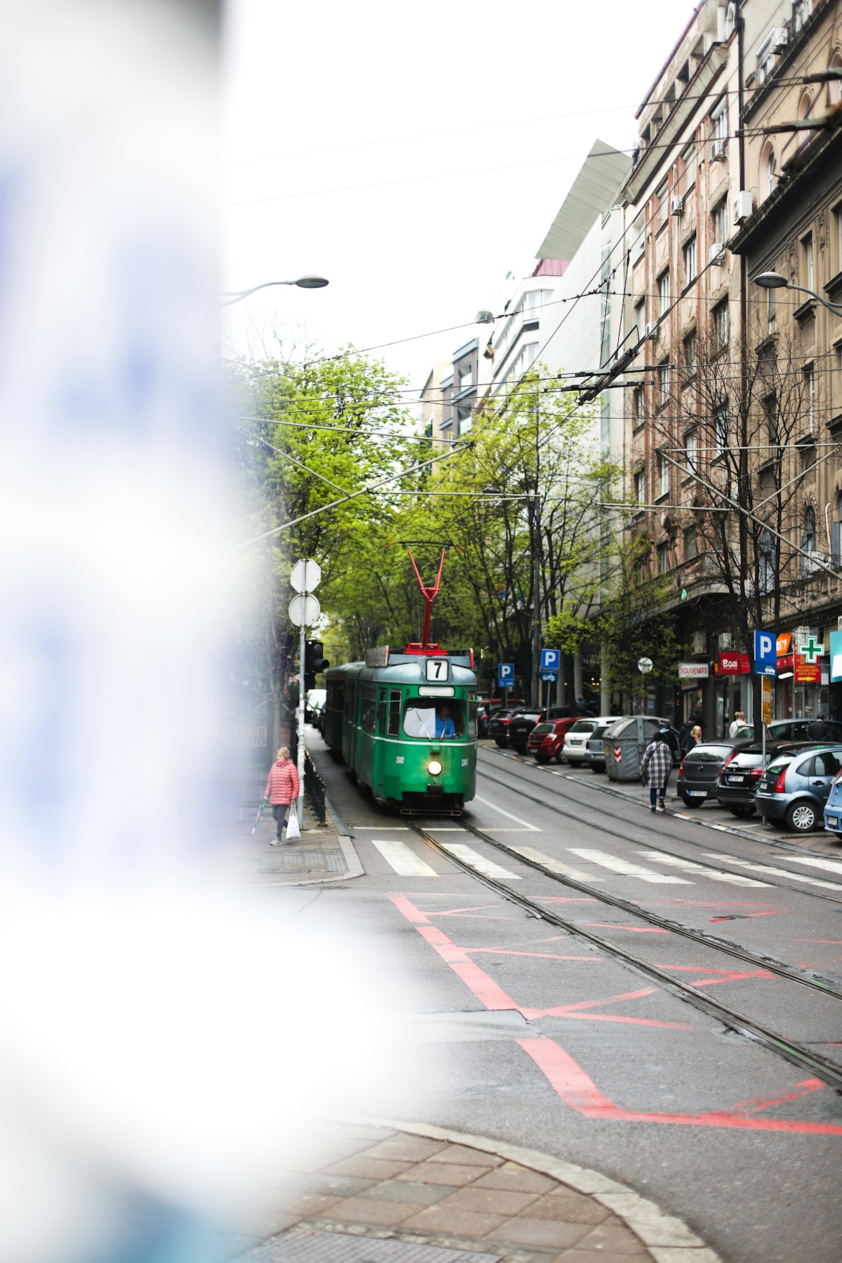 Green tram on a city street in Belgrade, Serbia