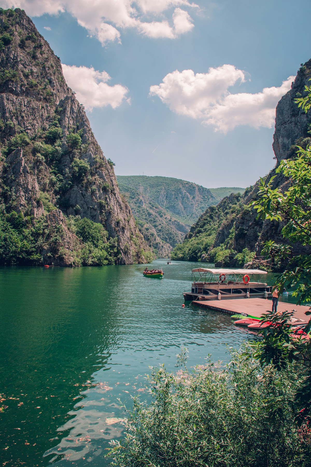 Calm emerald water in Matka Canyon surrounded by mountains, North Macedonia
