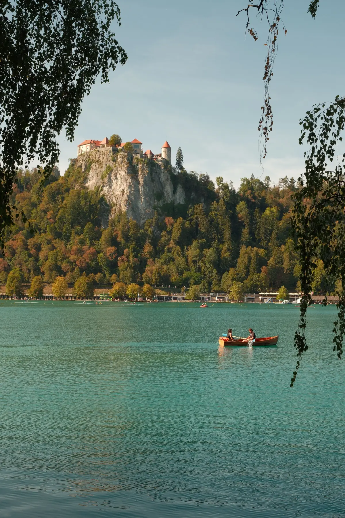 Bled Castle perched on a cliff above the emerald waters of Lake Bled, Slovenia