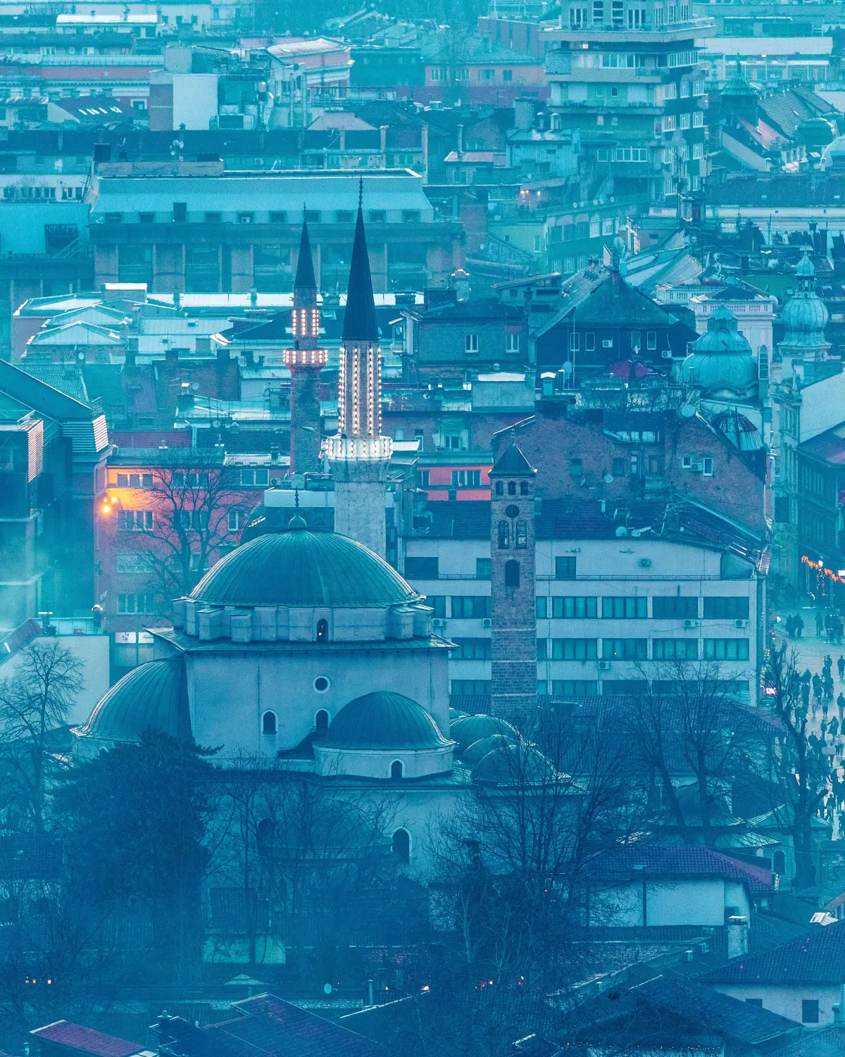 Sarajevo skyline at dusk with mosque domes and minarets illuminated, Bosnia and Herzegovina