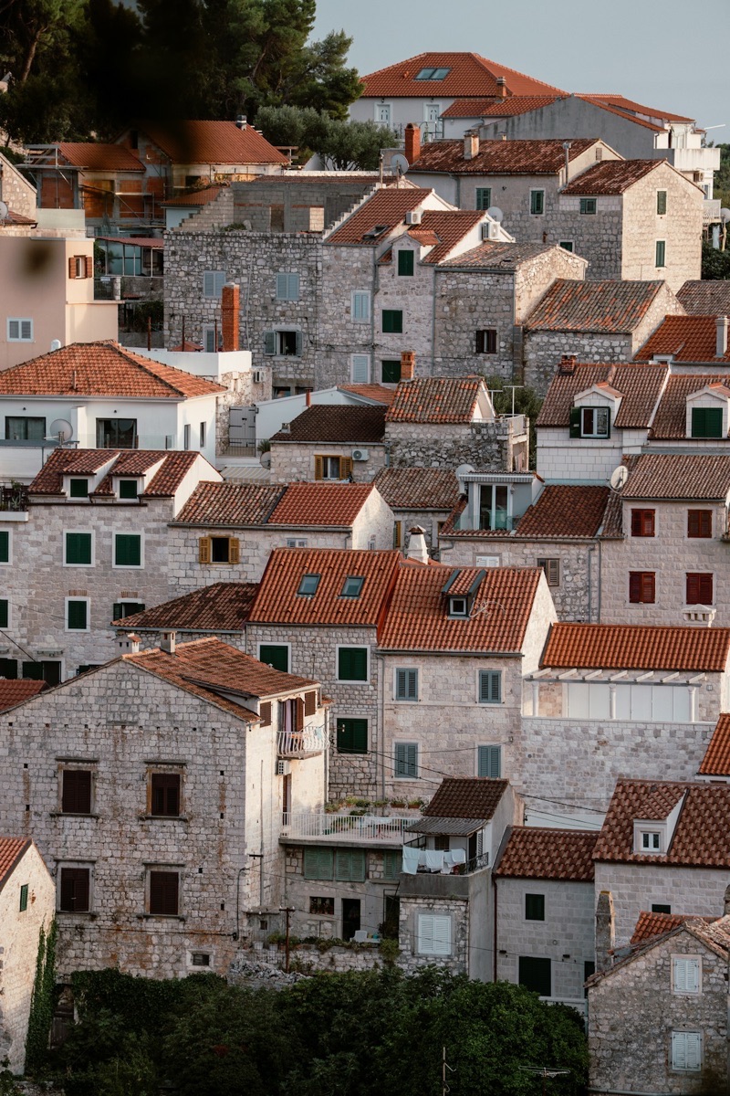 Stone buildings with terracotta roofs in a Dalmatian coastal town, Croatia