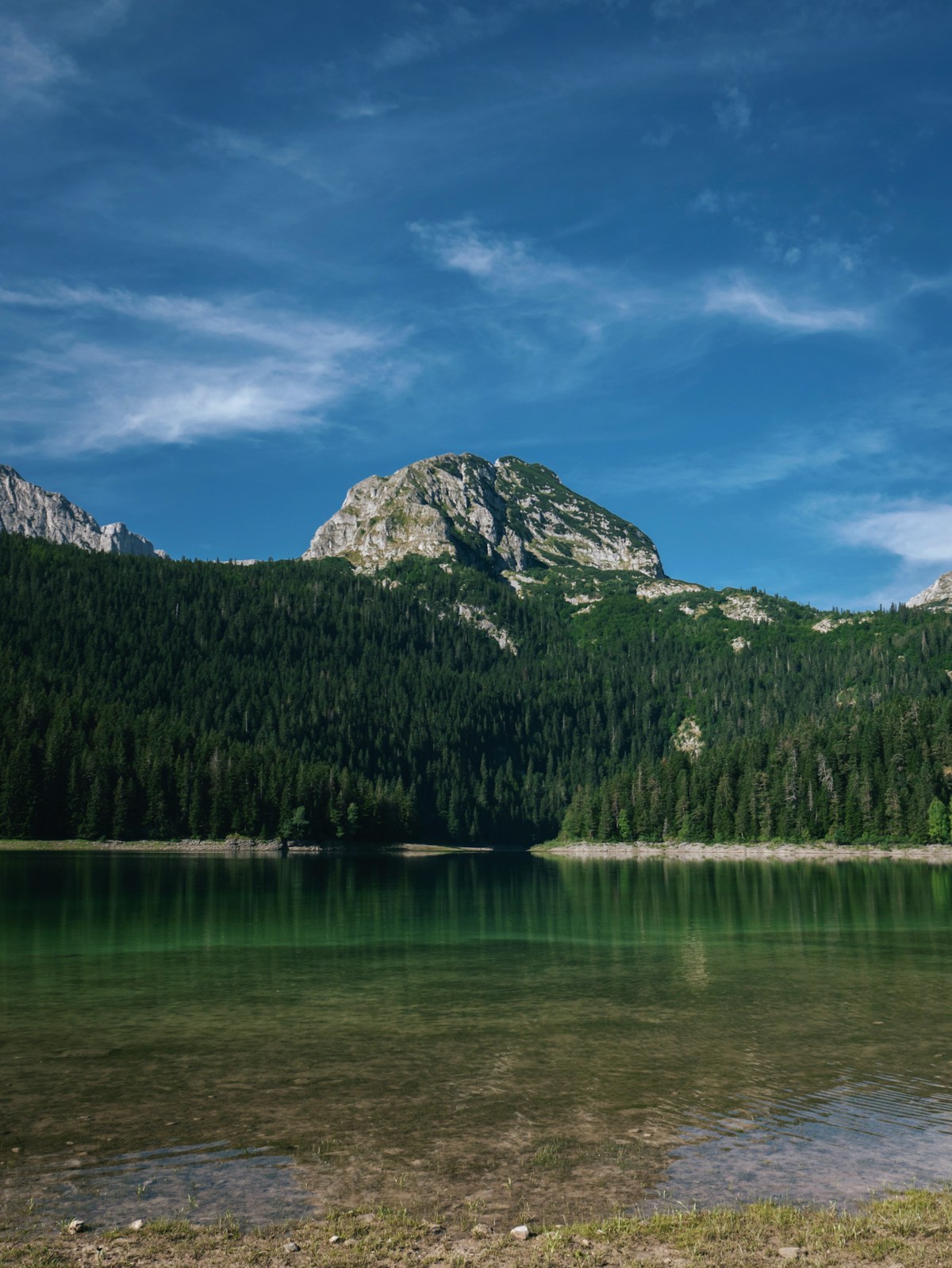 Black Lake surrounded by mountains in Durmitor National Park, Montenegro