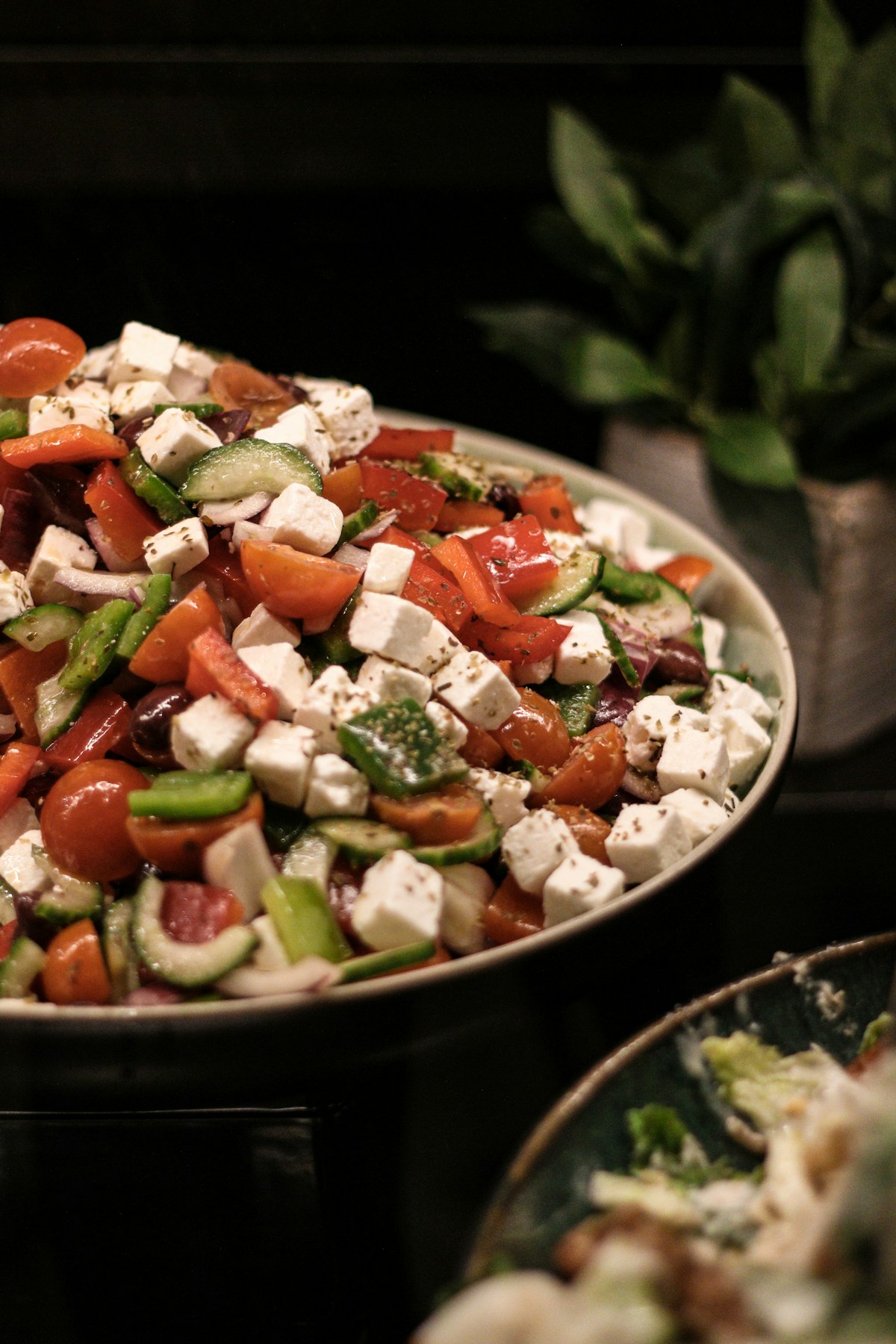 Bowl of shopska-style salad with tomatoes, cucumbers, green pepper and white feta cheese