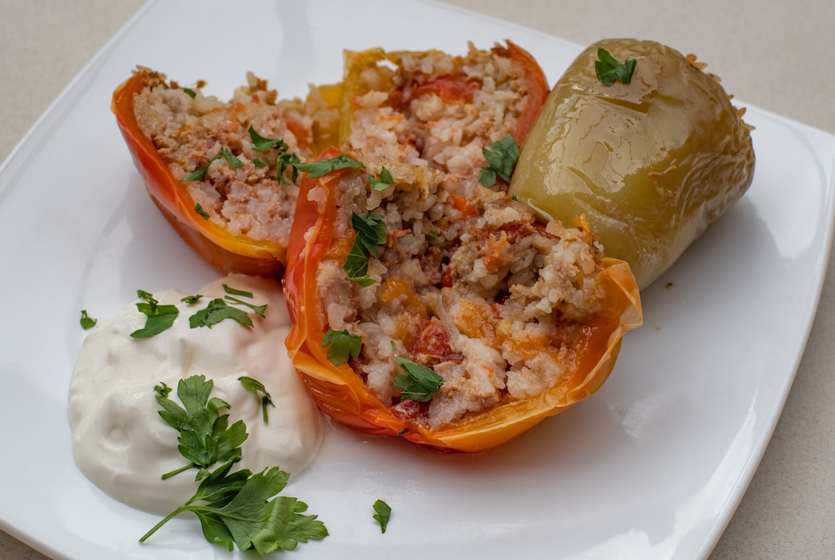 Plate of stuffed bell peppers with yogurt — a traditional vegetarian dish in Kosovo
