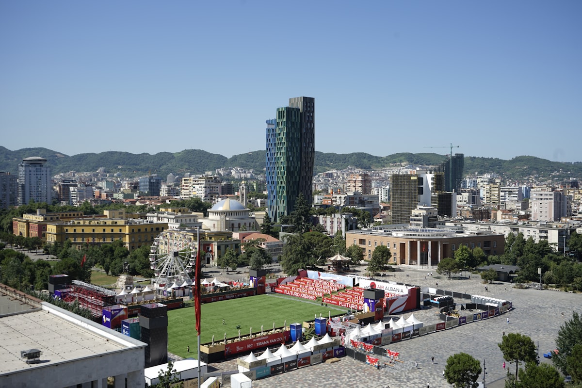 Aerial view of Tirana, Albania, with the TID Tower and Skanderbeg Square visible across the city skyline