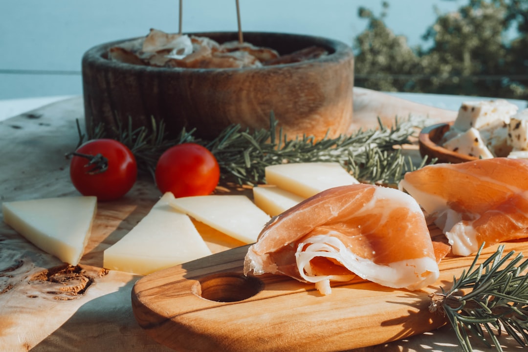 Smoked prosciutto, local cheese and rosemary served on a wooden board in Herceg Novi, Montenegro