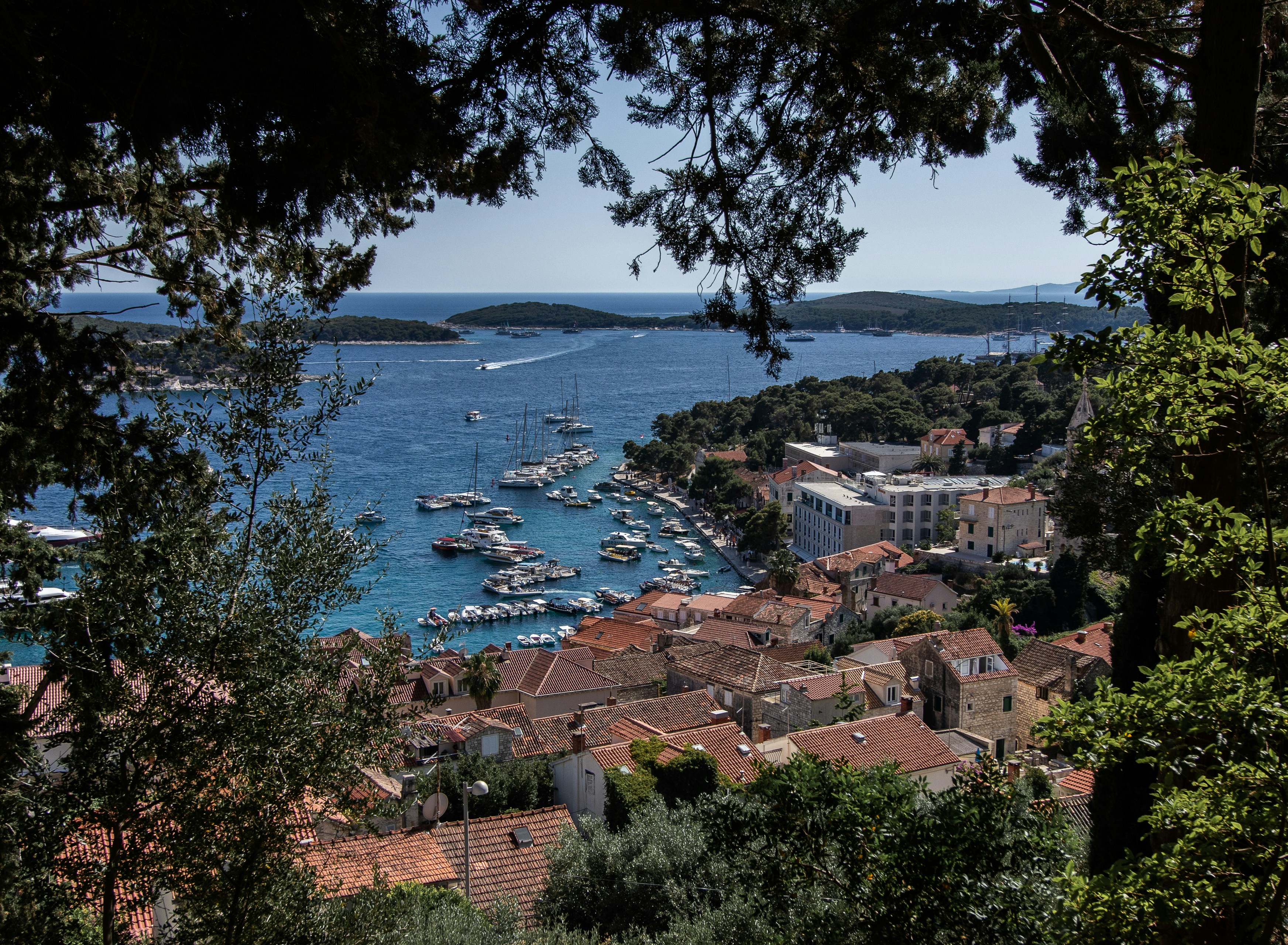 View of Hvar Town harbour with red-roofed buildings and boats, Croatia