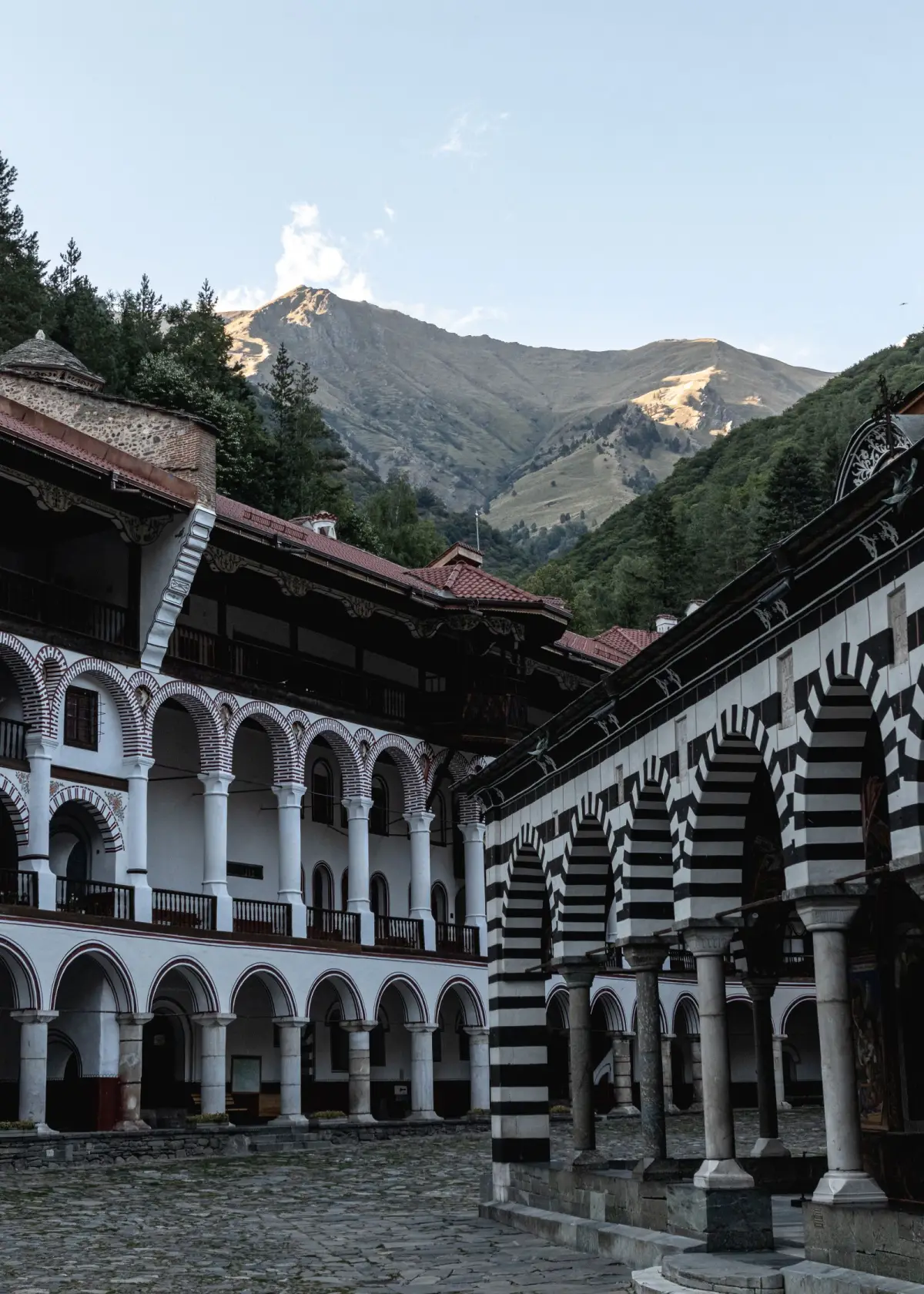 Striped arches and courtyard of Rila Monastery below the Rila Mountains, Bulgaria