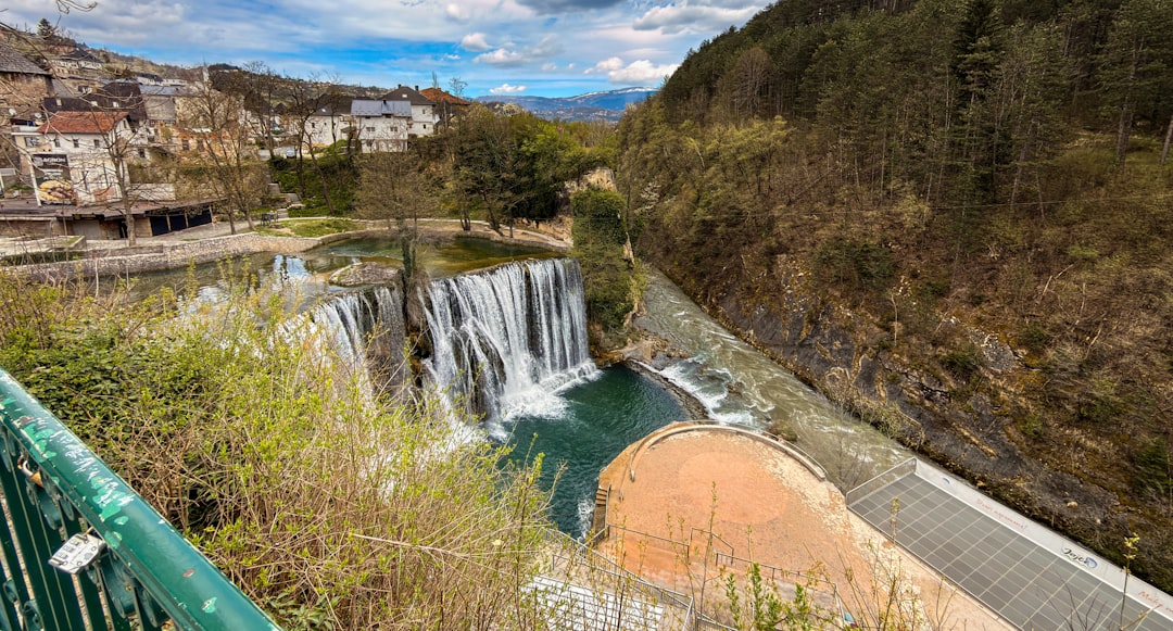 The famous Jajce waterfall cascading into a turquoise pool below the old town, Bosnia and Herzegovina
