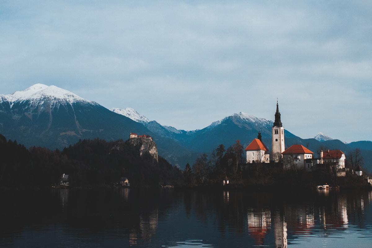 Lake Bled with Bled Island church, castle on the cliff, and Julian Alps behind