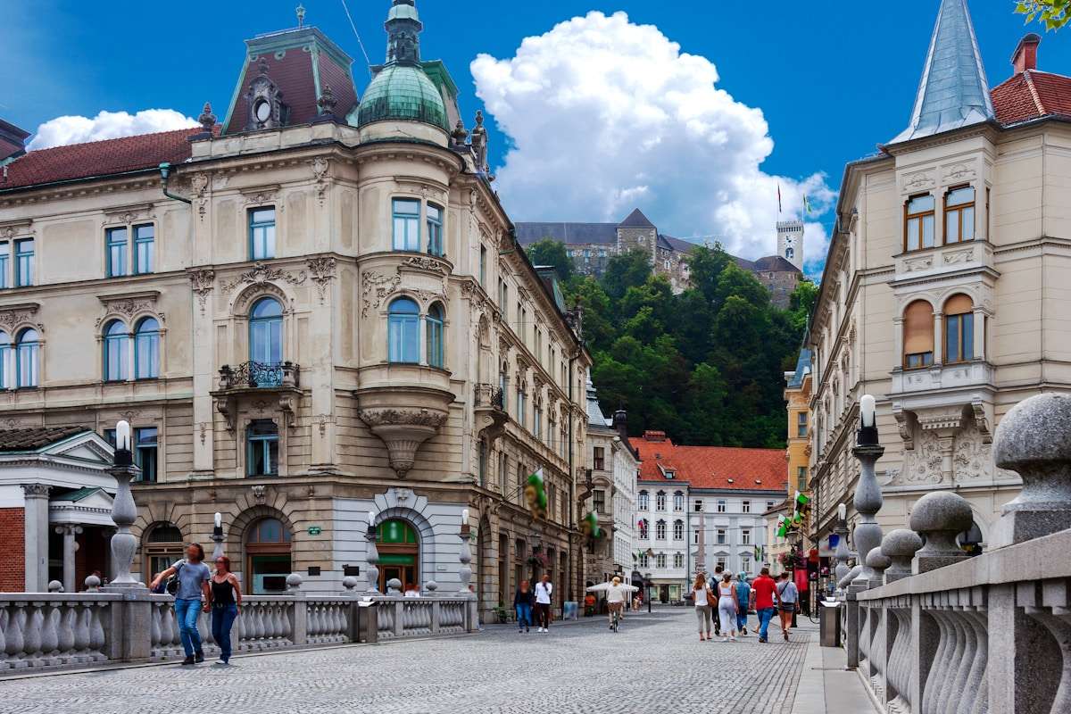 People walking on street near historic buildings in Ljubljana, Slovenia