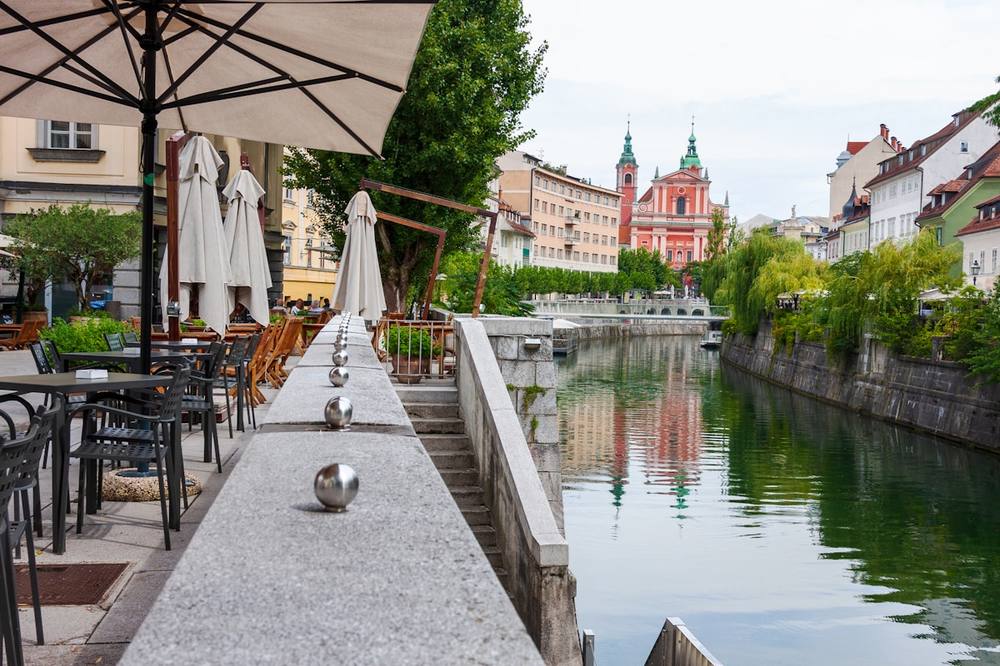 Outdoor cafe terrace by the Ljubljanica river, Ljubljana, Slovenia