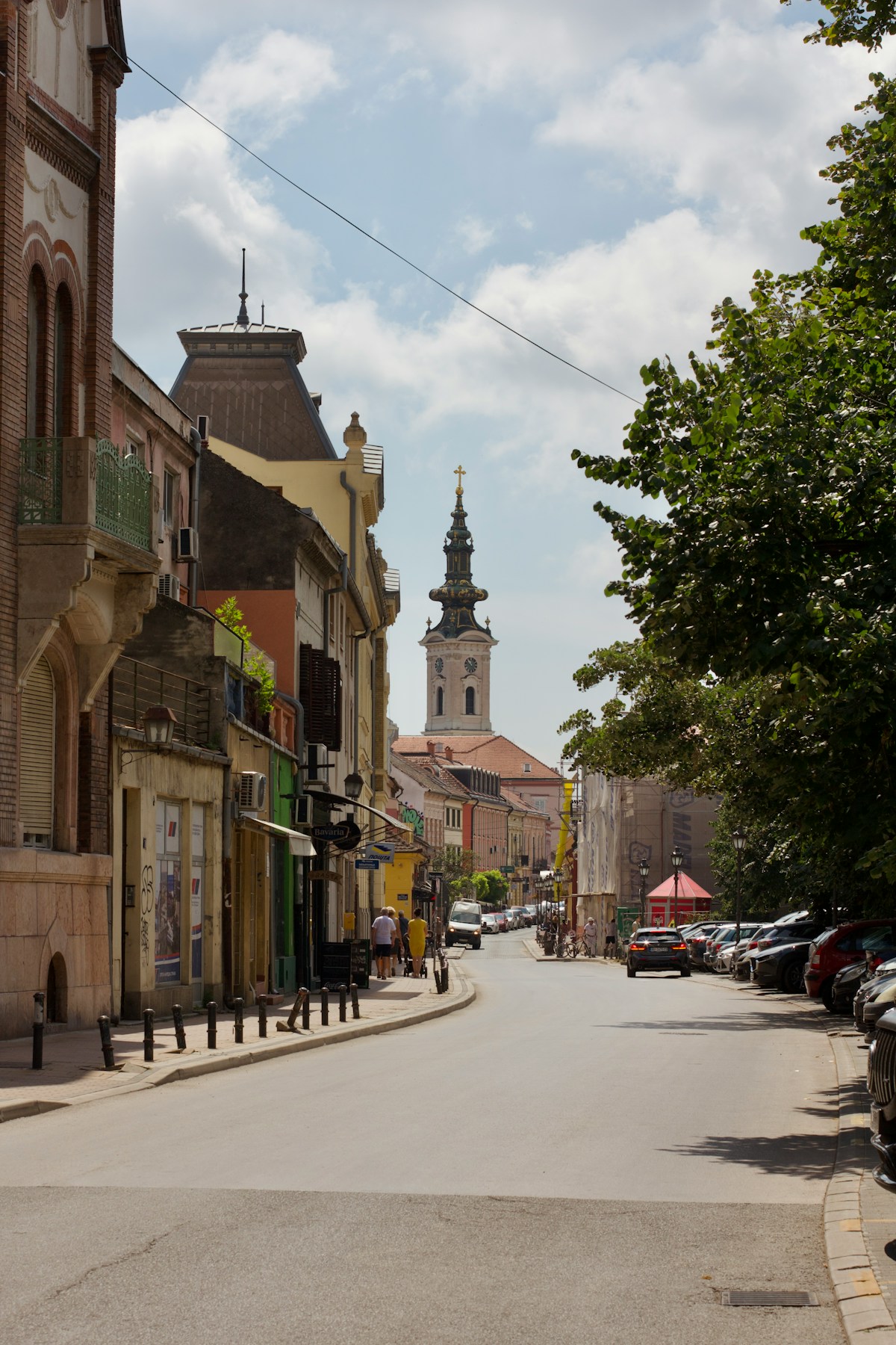City street with a clock tower in Novi Sad, Serbia