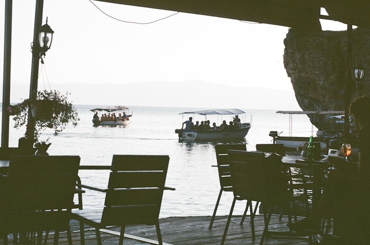 Lakeside cafe terrace in Ohrid with boats on Lake Ohrid, North Macedonia