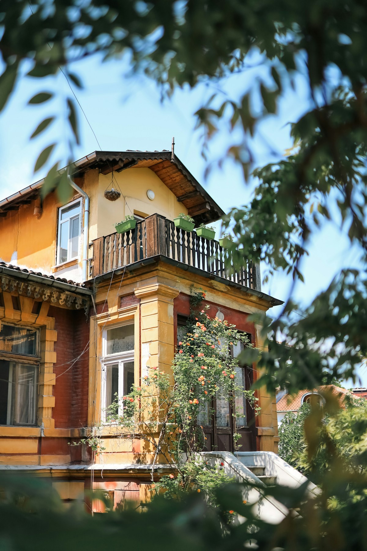 Traditional Bulgarian yellow house with balcony in Plovdiv old town