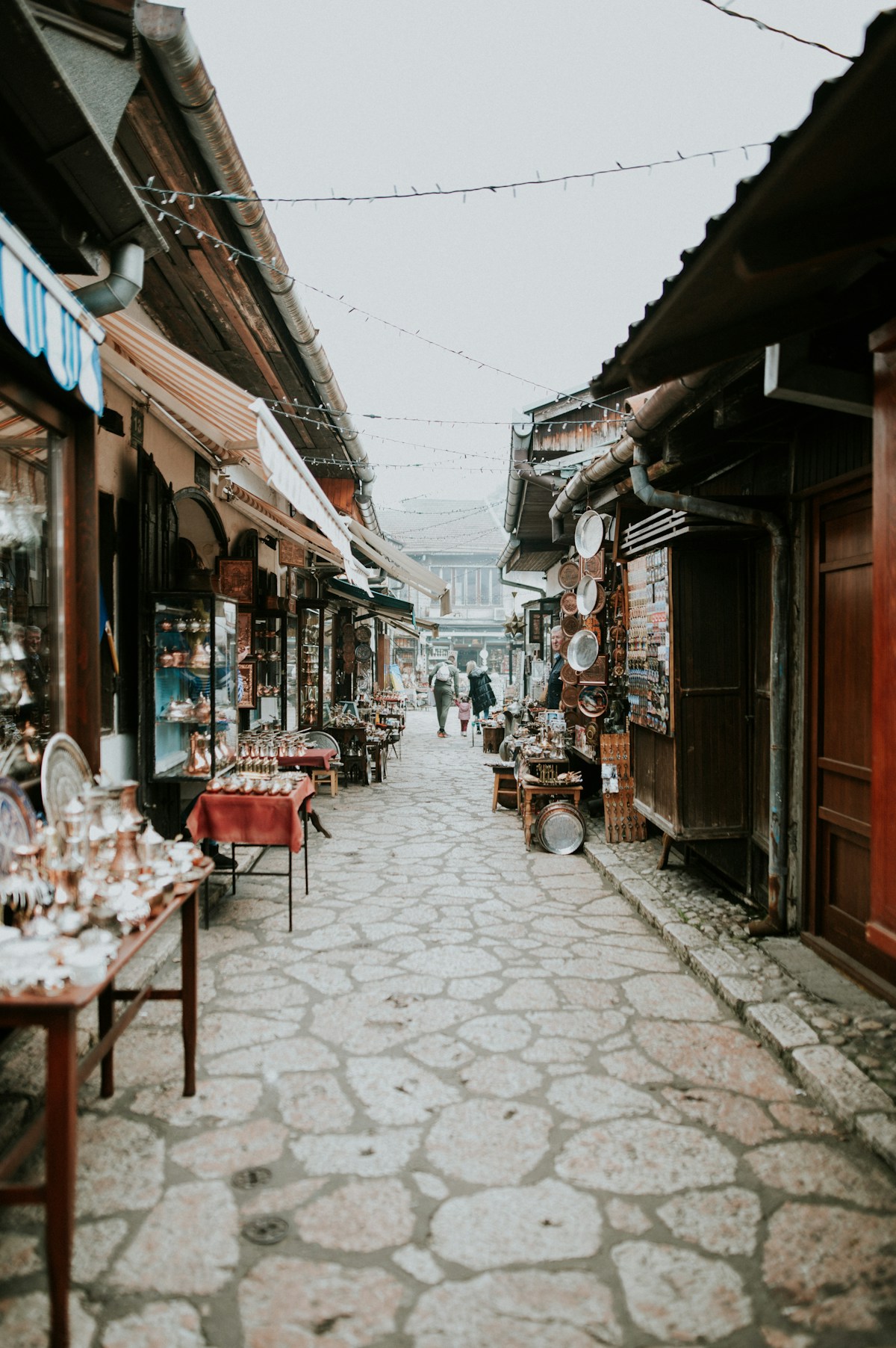 Cobblestone street lined with shops and people in Sarajevo, Bosnia and Herzegovina