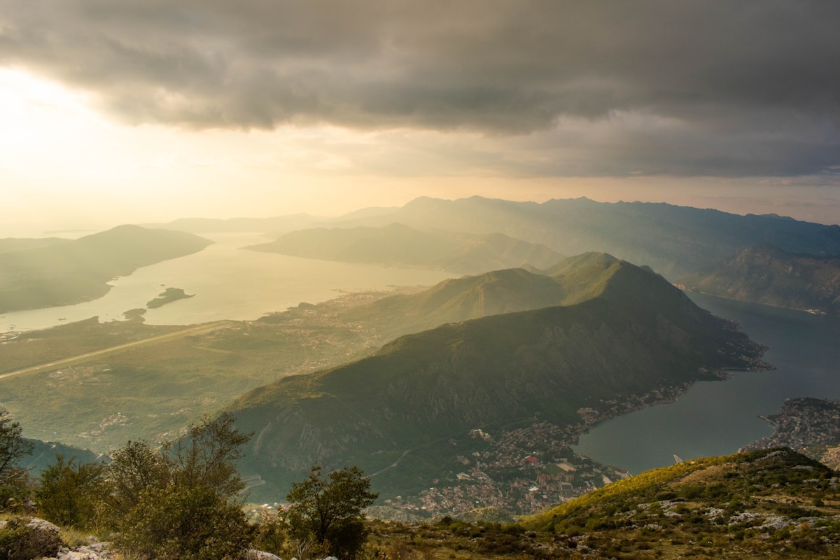 Mountain range with body of water in the distance, Montenegro — best time to visit the Balkans