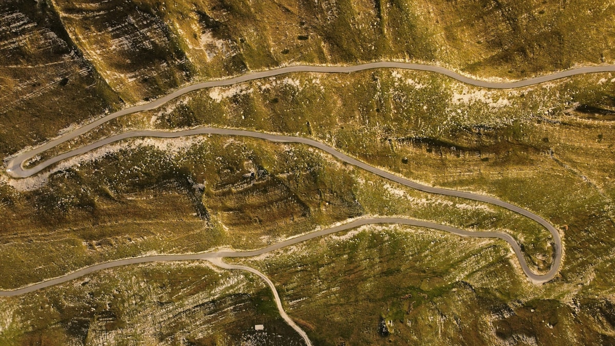 Aerial view of a winding mountain road - car rental in the Balkans