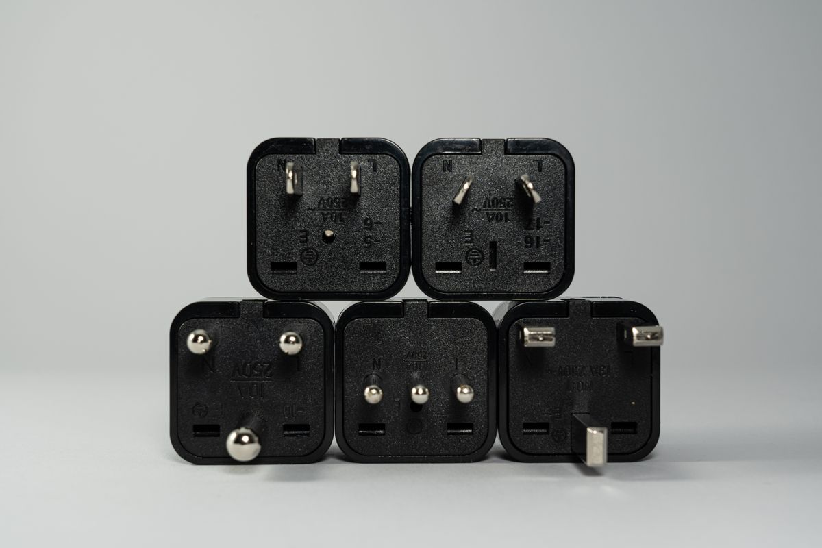 Black international travel power plug adapters laid out together