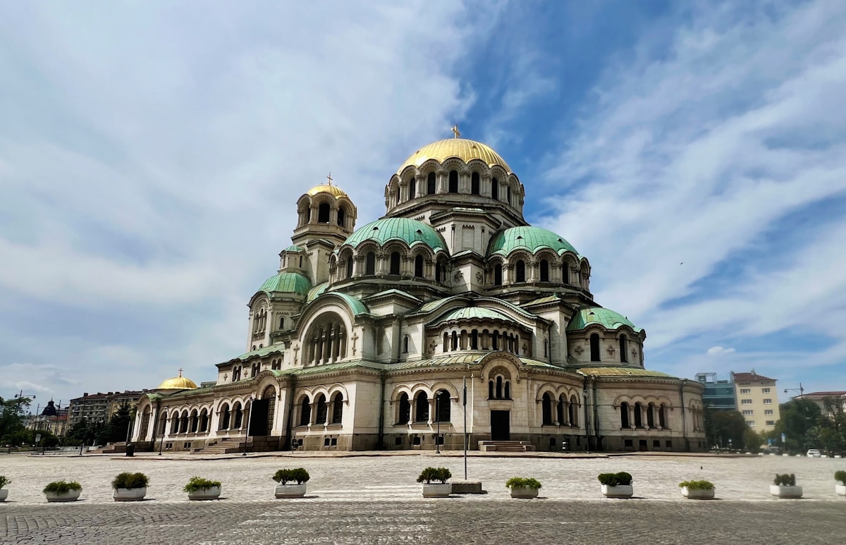 St. Alexander Nevsky Cathedral with gold and green domes under blue sky, Sofia, Bulgaria