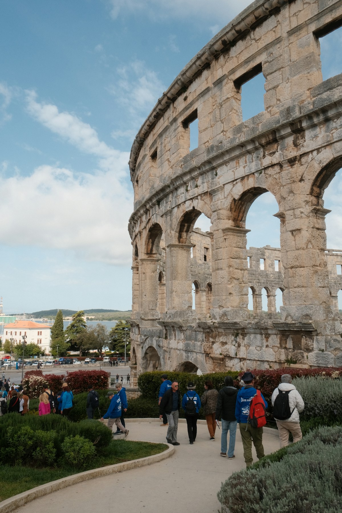 Visitors walking outside the Pula Arena Roman amphitheatre, Istria, Croatia