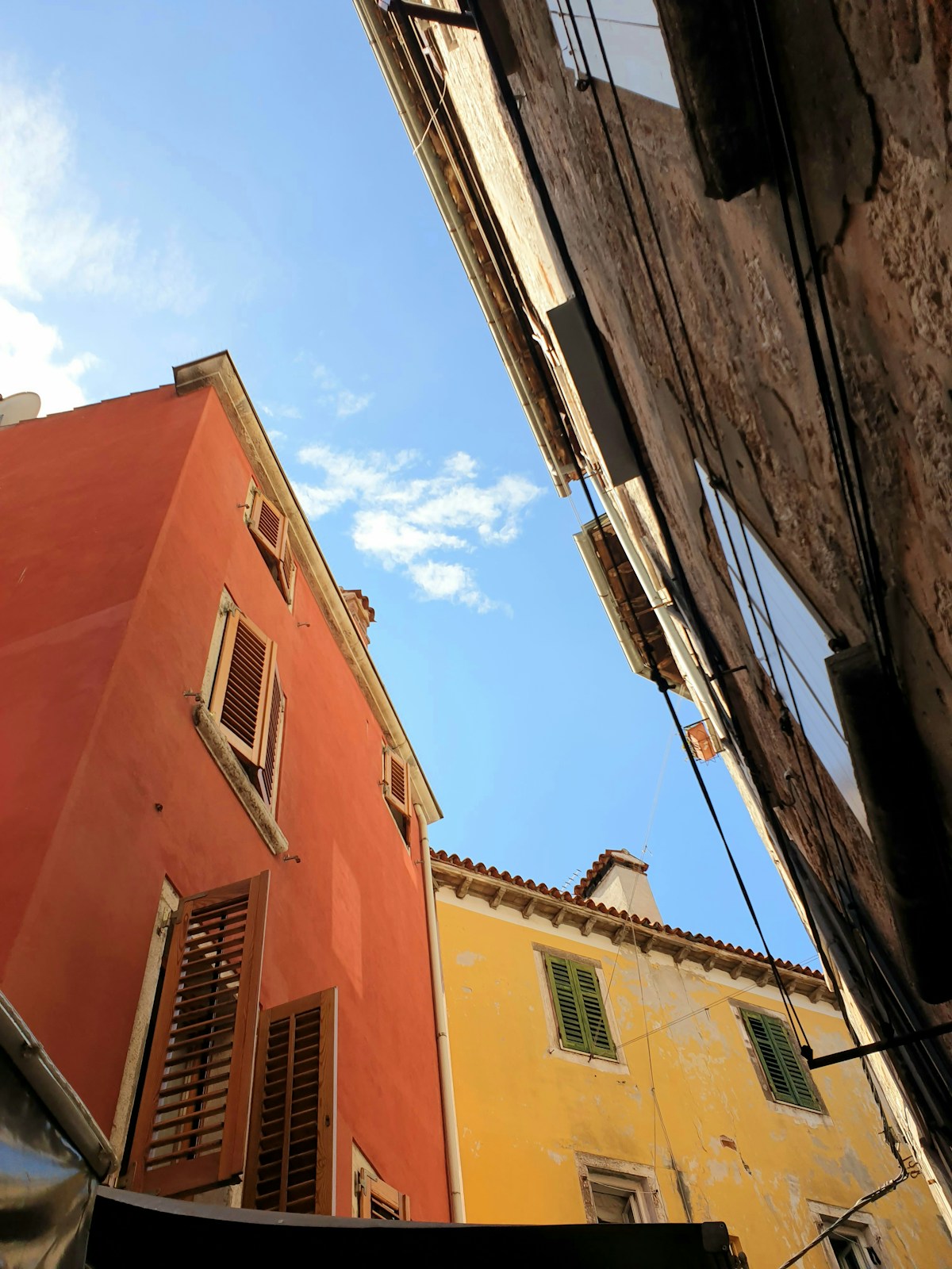 Looking up at colourful buildings in Rovinj old town, Croatia