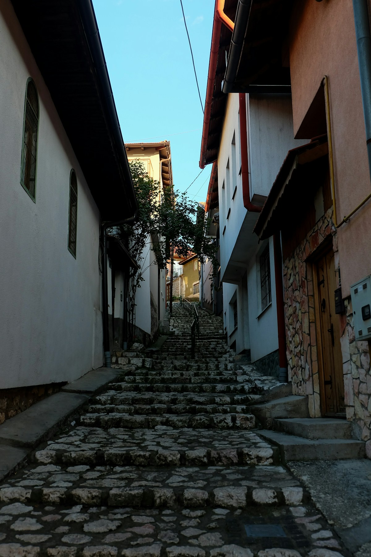 Stone staircase winding through old buildings in Sarajevo, Bosnia