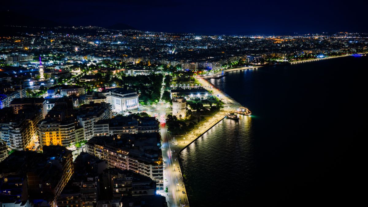Aerial night view of Thessaloniki waterfront with the illuminated White Tower and Thermaic Gulf, Greece