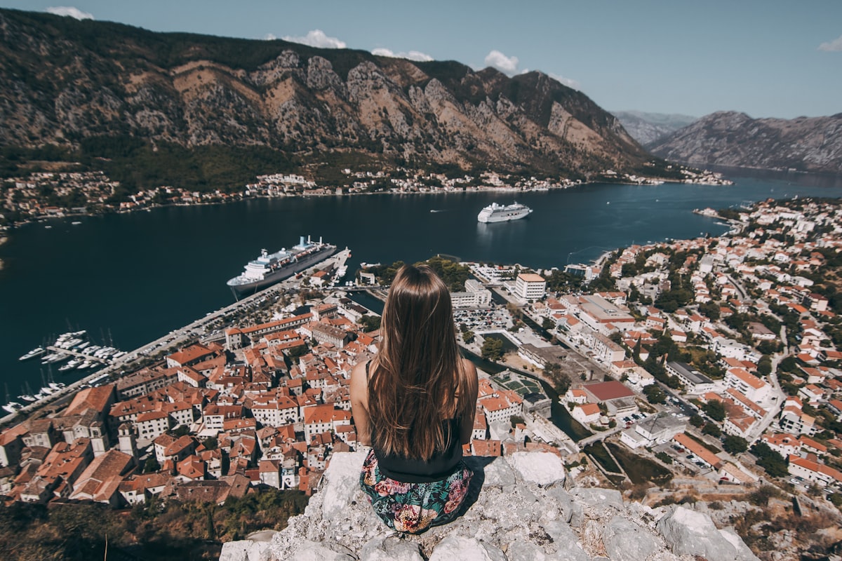 Solo woman overlooking Kotor Bay from the fortress walls, Montenegro