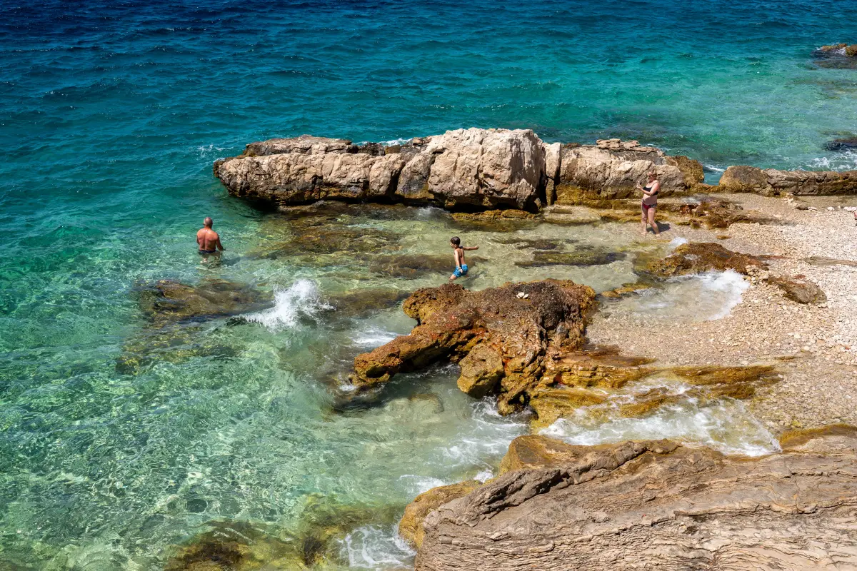 Family beach scene on the Adriatic coast at Primošten, Croatia