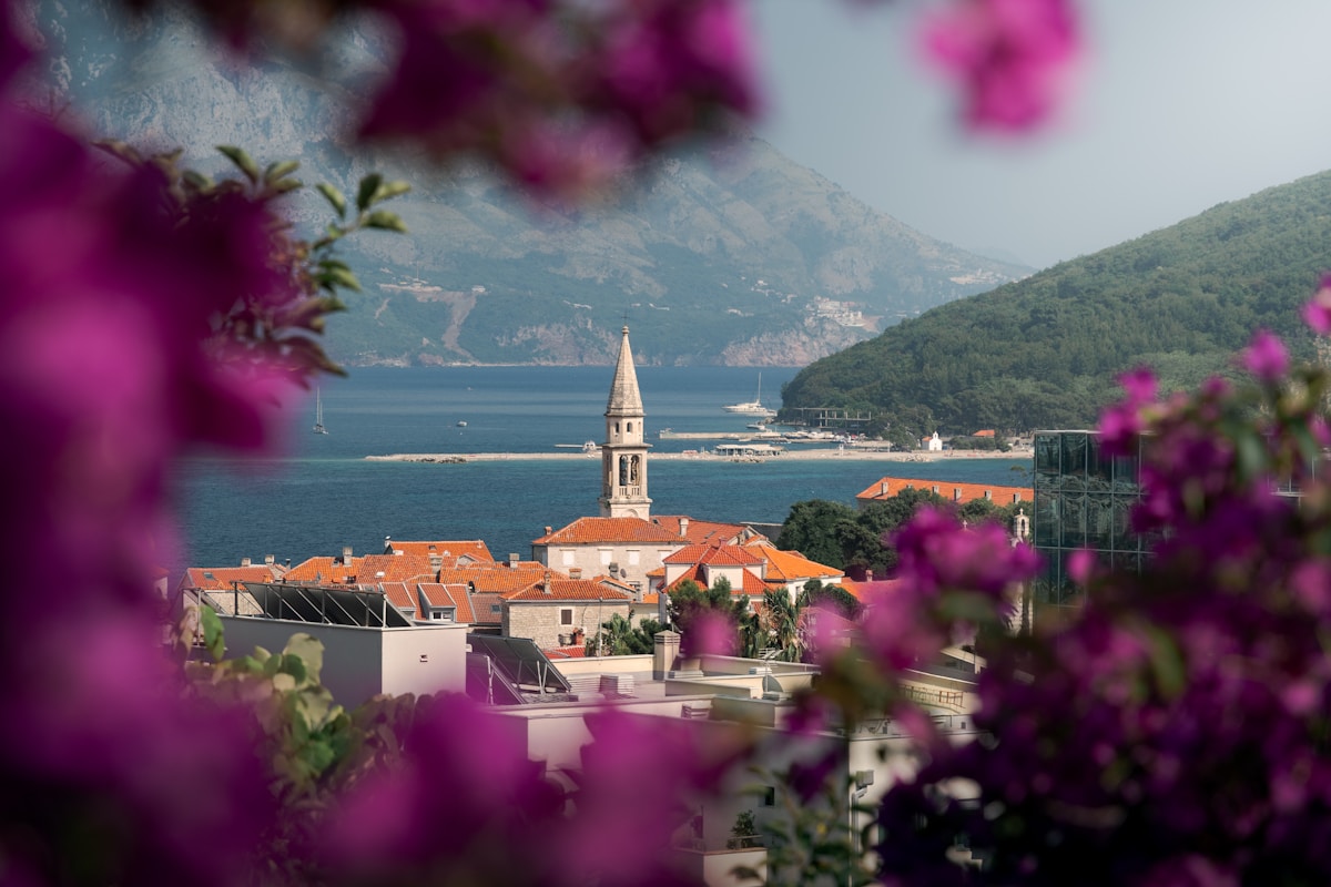 Coastal town of Budva with bell tower and mountains rising behind, Montenegro