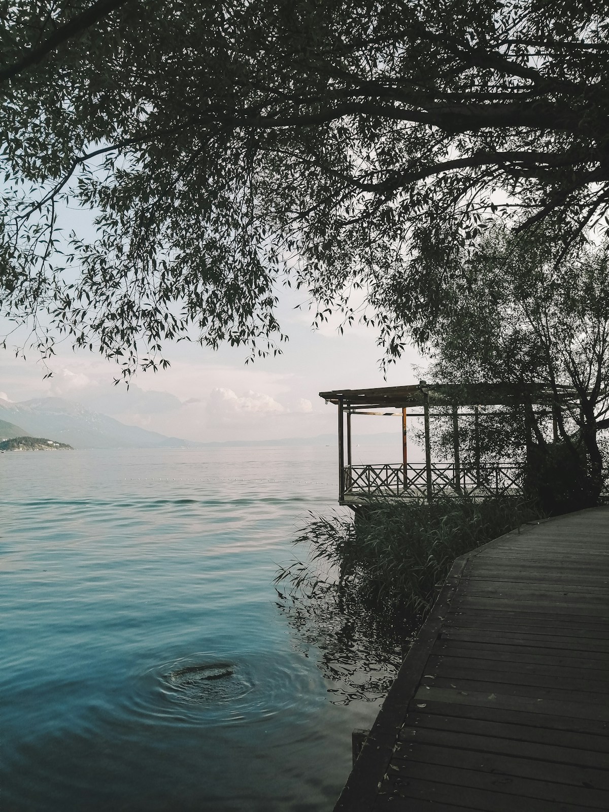 Lakeside pavilion gazebo at the edge of Lake Ohrid with mountains in the background, North Macedonia