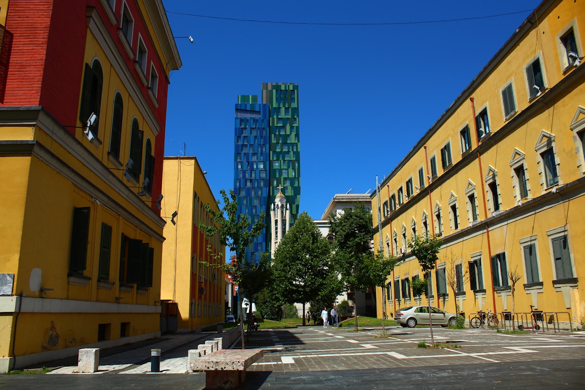 City street lined with colourful buildings and modern tower in central Tirana, Albania