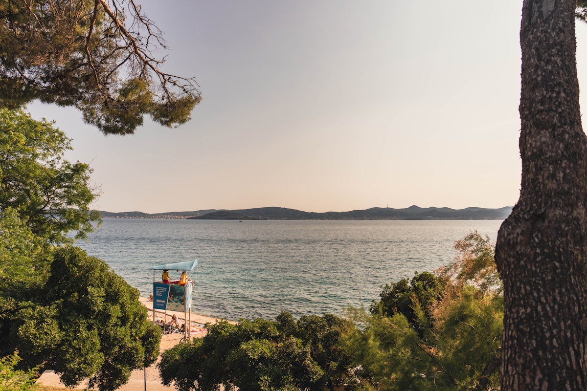 People on a bench by the seafront in Zadar, Croatia